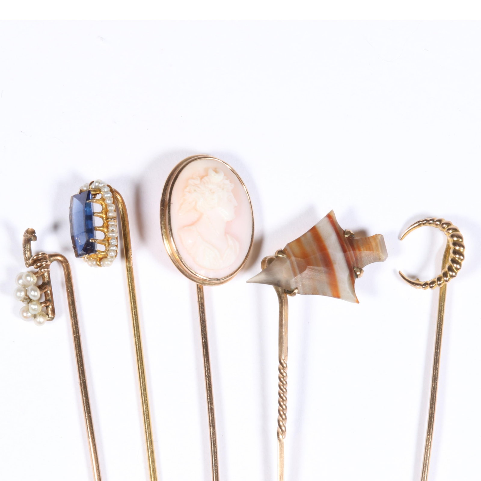 5pc 10K Yellow Gold Antique Stick Pin Group with Coral Cameo, Seed Pearls, Agate, and Sapphire,: 5pc 10K Yellow Gold Antique Stick Pin Group with Coral Cameo, Seed Pearls, Agate, and Sapphire, Marked and Unmarked, Tested 3.9dwt. total The oval sapphire is synthetic The purchase of gold requires c