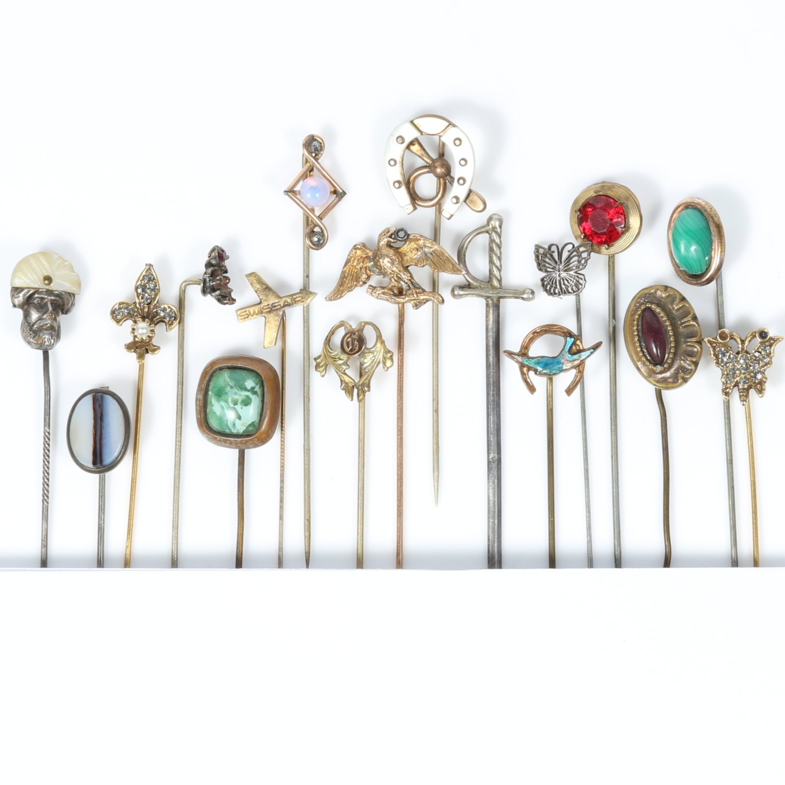 17pc Victorian stick pin group including horseshoe with MOP, Scottish agate, malachite, sword,: 17pc Victorian stick pin group including horseshoe with MOP, Scottish agate, malachite, sword, eagle, fleur-de-leis, butterflies, and more Provenance: From the collection of Sue Rudman, owner of Antiq