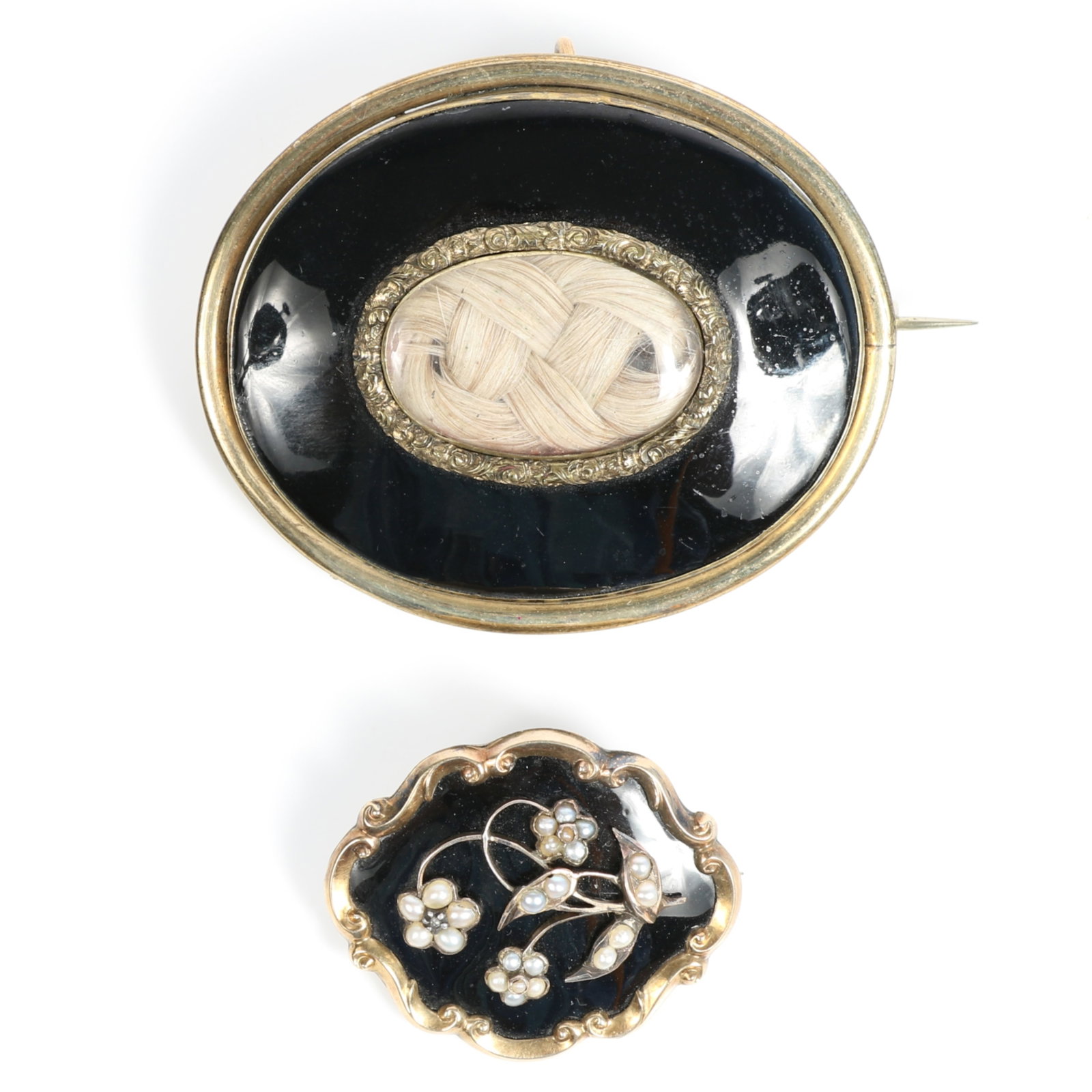 Pair of Victorian mourning hair jewelry brooches with black enamel, and a seed pearl floral design.: Pair of Victorian mourning hair jewelry brooches with black enamel, and a seed pearl floral design. One is hand engraved on the back Provenance: From the Collection of Joan Duran, owner of The Queen's