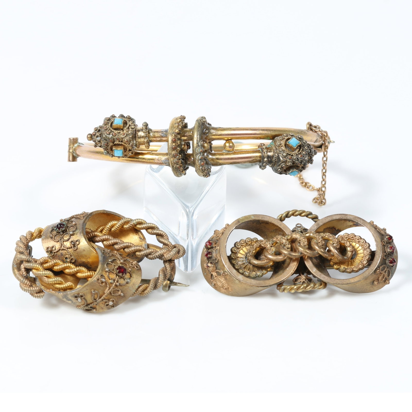 Victorian Etruscan revival double snake hinged bracelet with faux turquoise eyes and pair of: Victorian Etruscan revival double snake hinged bracelet with faux turquoise eyes and pair of intertwined knot broches with red jewels Provenance: From the Collection of Joan Duran, owner of The Queen'