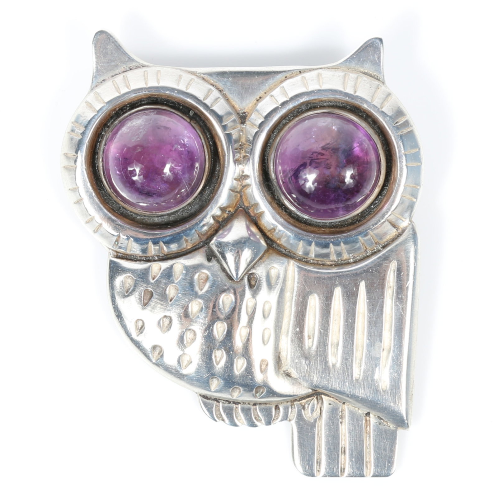 William Spratling Mexican silver stylized owl brooch with large amethyst cabochon eyes 2 1/2"H x 1: William Spratling Mexican silver stylized owl brooch with large amethyst cabochon eyes The back of the brooch is stamped: "980" Provenance: From the Collection of Joan Duran, owner of The Queen's Bedr