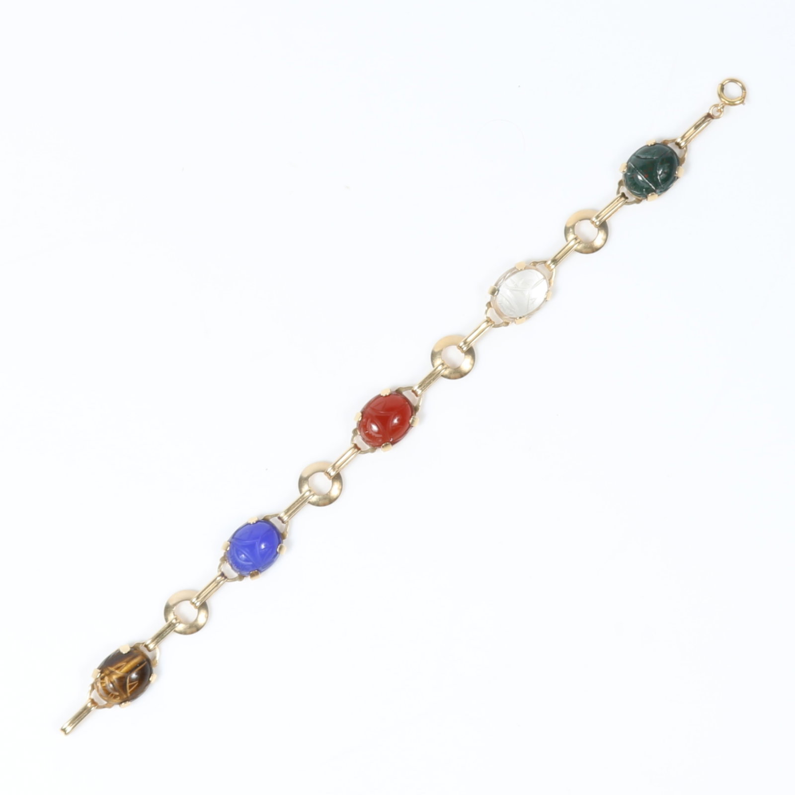 14k Yellow gold scarab bracelet with rock crystal, tigers eye, carnelian, and bloodstone 7 1/2"L x: 14k Yellow gold scarab bracelet with rock crystal, tigers eye, carnelian, and bloodstone 6.50 dwt The purchase of gold requires confirmed funds 7 1/2"L x 3/8"W
