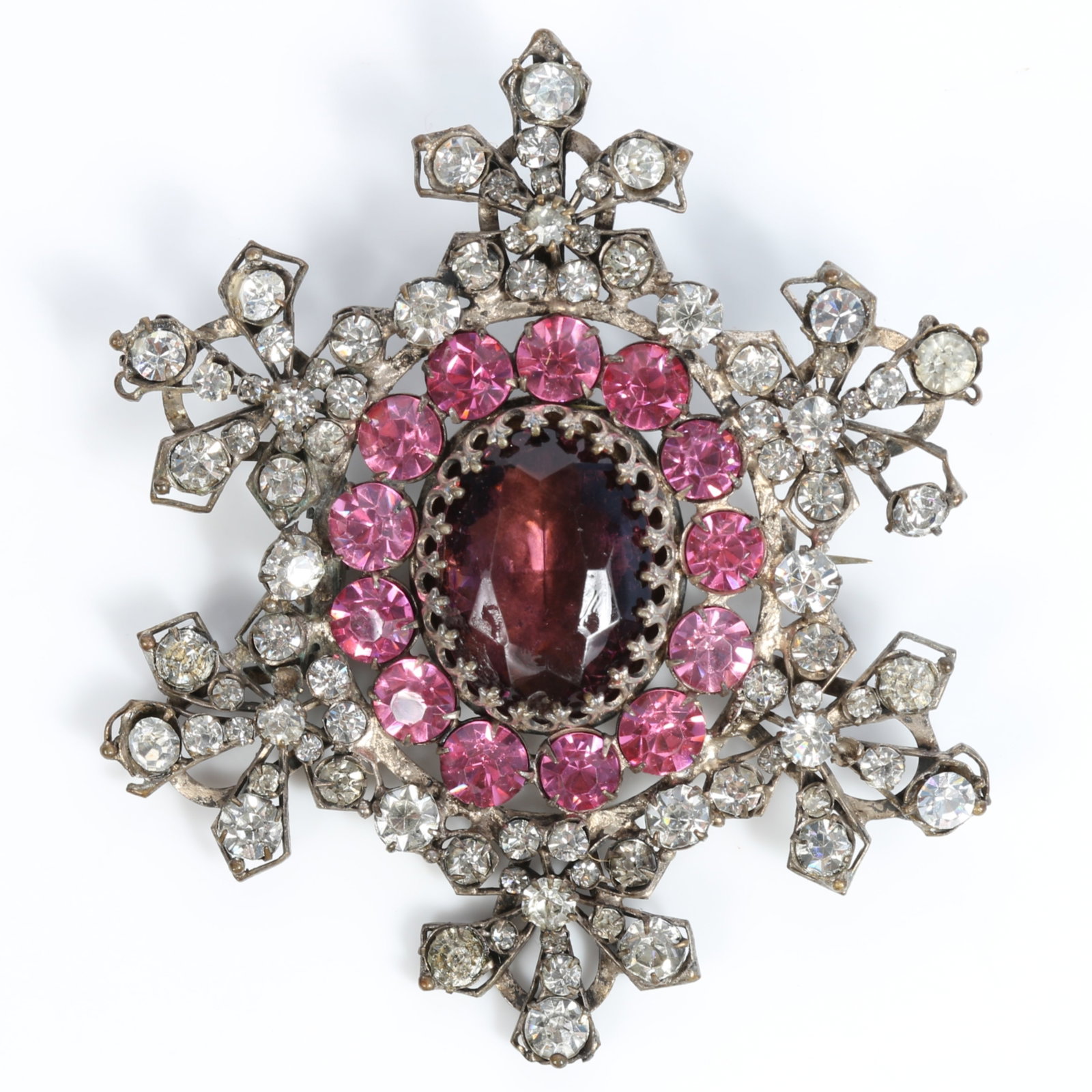 HUGE Victorian paste brooch with dark amethyst center jewel surrounded by bright pink crystals 3: HUGE Victorian paste brooch with dark amethyst center jewel surrounded by bright pink crystals Provenance: From the Collection of Joan Duran, owner of The Queen's Bedroom on Facebook 3 1/2"H x 3"W