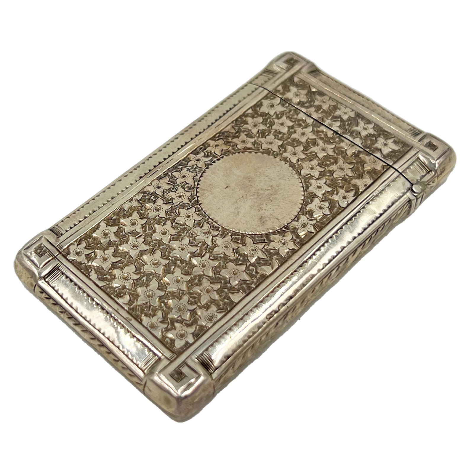 A SILVER CARD CASE WITH FLOWER DECORATION TO THE BODY, BIRMINGHAM, BY HILLIARD AND THOMASON, 1866 (1 of 4)