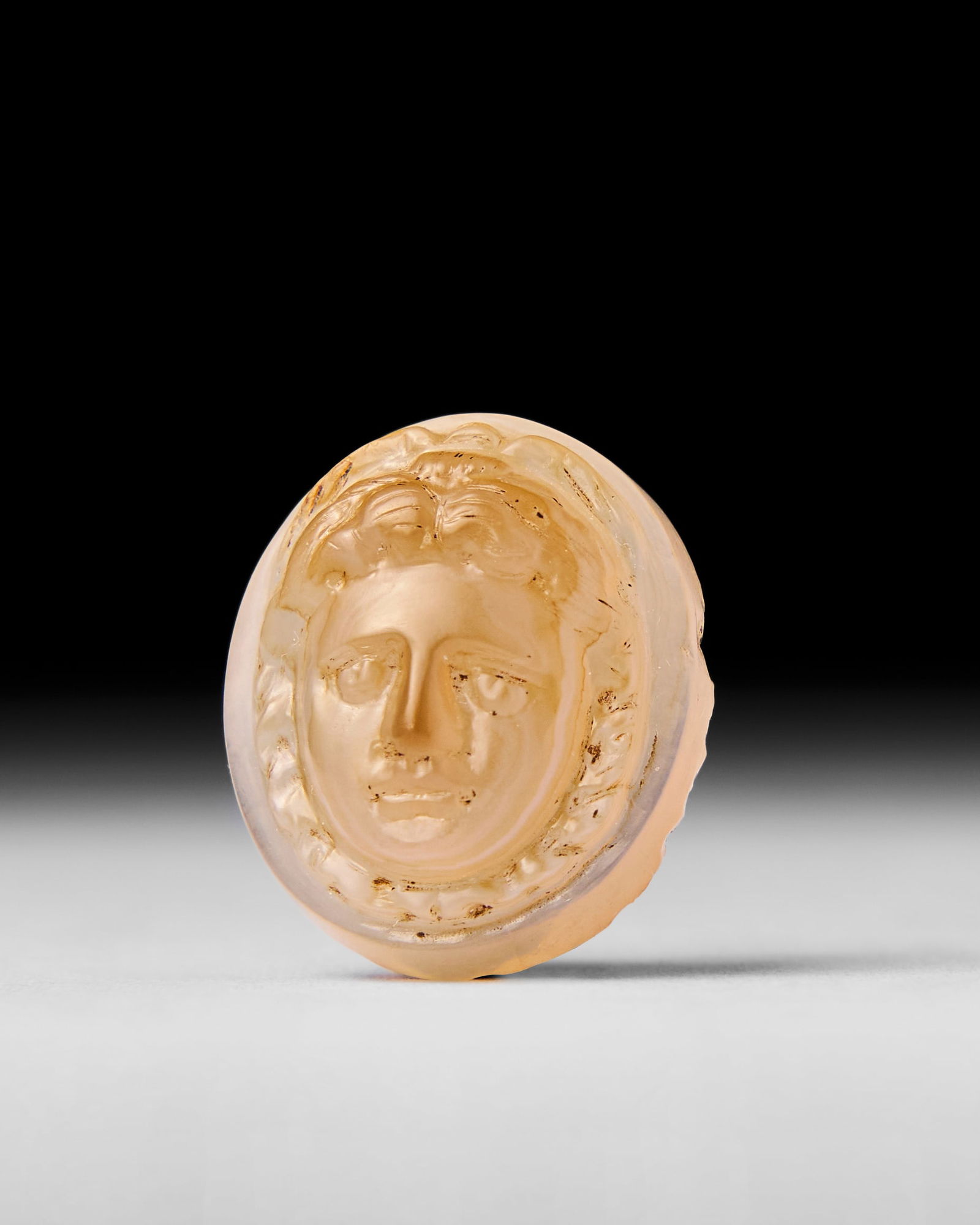 A ROMAN AGATE CAMEO WITH THE HEAD OF MEDUSA, 2ND - 3RD CENTURY A.D.: This finely crafted Roman agate cameo dates back to the 2nd - 3rd century A.D. The piece beautifully depicts the head of Medusa, a mythological figure revered for her role as both protector and symbol