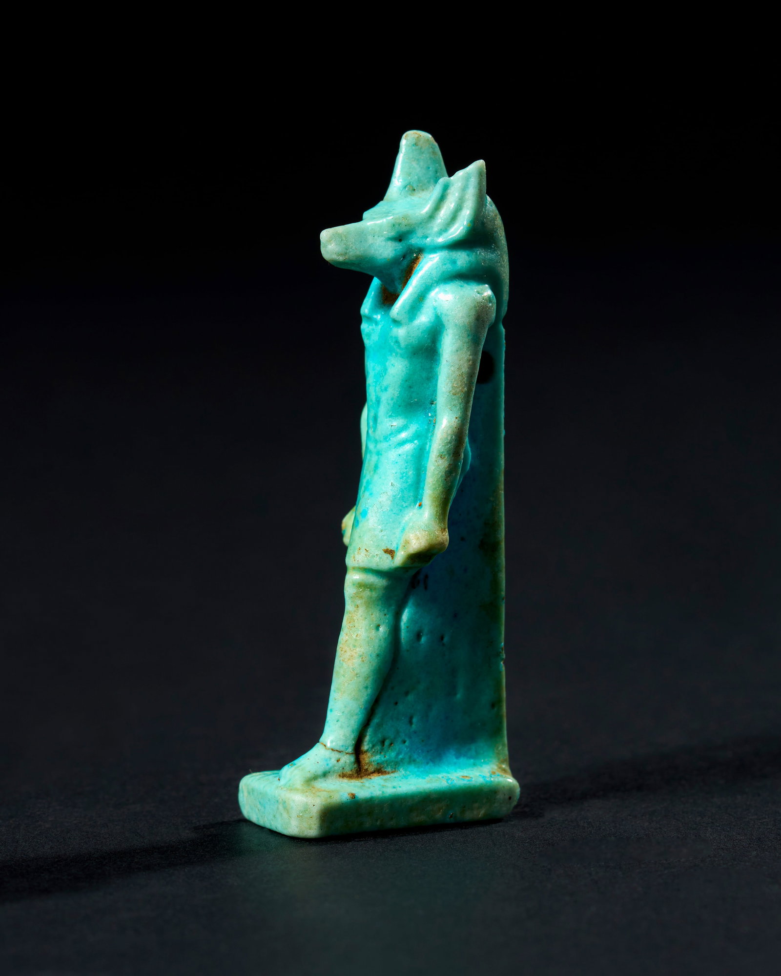 AN EGYPTIAN FAIENCE AMULET DEPICTING ANUBIS, LATE PERIOD TO PTOLEMAIC PERIOD, 664-30 B.C. (1 of 4)