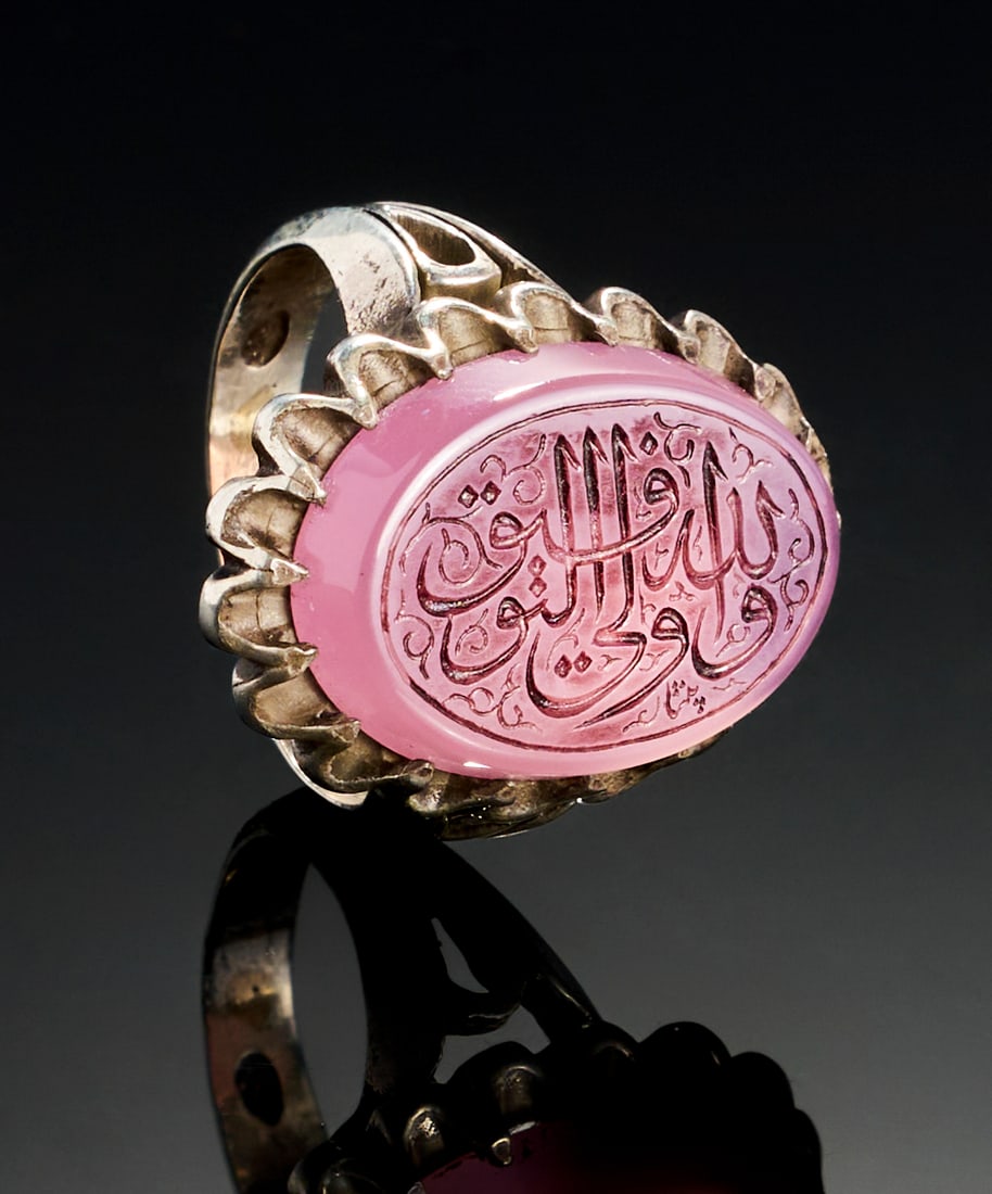 A PINK STONE WITH ISLAMIC CALLIGRAPHY IN A SILVER RING (1 of 3)