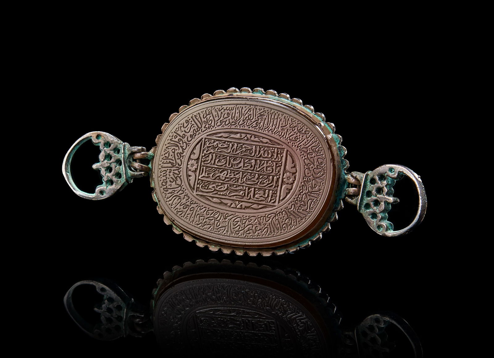 A QAJAR SILVER MOUNTED ENGRAVED AGATE BAZU BAND, 19TH CENTURY (1 of 2)
