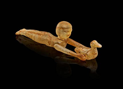 AN EGYPTIAN ROCK CRYSTAL FIGURE OF A YOUNG FEMALE SWIMMER, NEW KINGDOM, 1400 - 1300 B.C.: A rare and exceptionally well-preserved Egyptian figure carved from translucent rock crystal, depicting a young female swimmer in a dynamic prone pose. Originating from the New Kingdom period, this ca