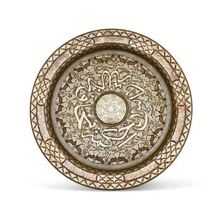 A MAMLUK REVIVAL DISH INLAID WITH GOLD, SILVER, COPPER AND BRASS, SYRIA, CIRCA 1900: An exceptional and visually striking Mamluk Revival dish, masterfully inlaid with gold, silver, copper, and brass, produced in Syria around the turn of the 20th century. The composition is centered a