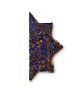 A HALF STAR SHAPE BLUE LAJVARDINA MOULDED POTTERY TILE, PERSIA, 12TH - 13TH CENTURY: A HALF STAR SHAPE BLUE LAJVARDINA MOULDED POTTERY TILE, PERSIA, 12TH - 13TH CENTURY 19.5 x 9.5cm 