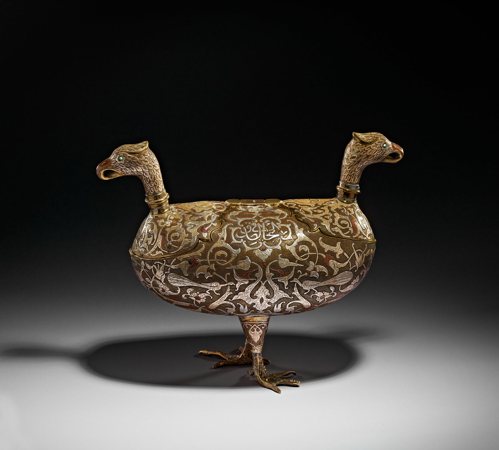 A DAMASCUS SILVER AND COPPER INLAID BRASS KASHKUL IN THE FORM OF TWO EAGLES, SYRIA, 20TH CENTURY (1 of 7)
