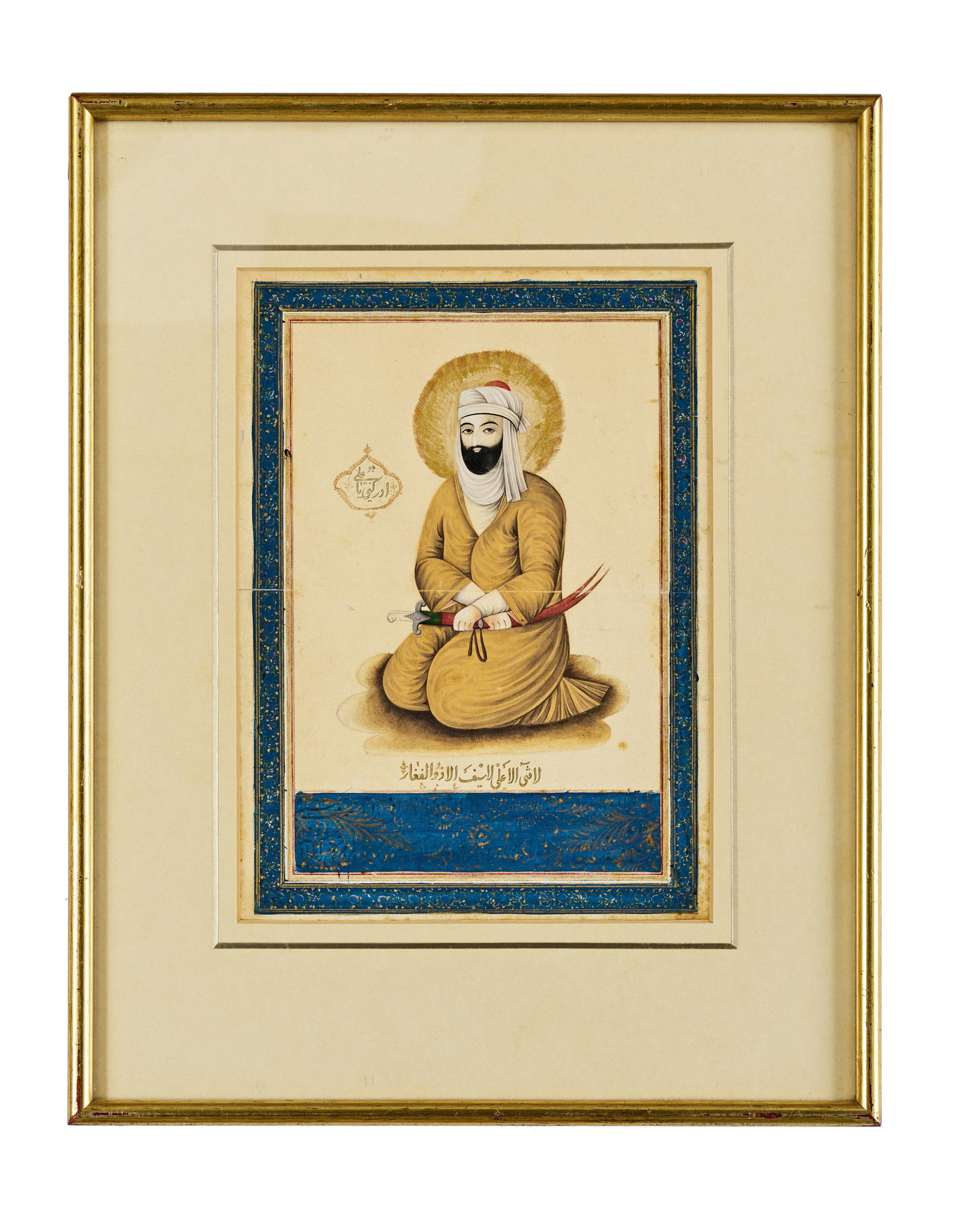 A PERSIAN QAJAR PAINTING OF IMAM ALI, 19TH CENTURY: Rendered in gouache and gold, depicting the figure seated with halo and sword, set within a rich blue and gold illuminated border. Provenance: Mohammed Mekkiya Collection, Christies London Pai