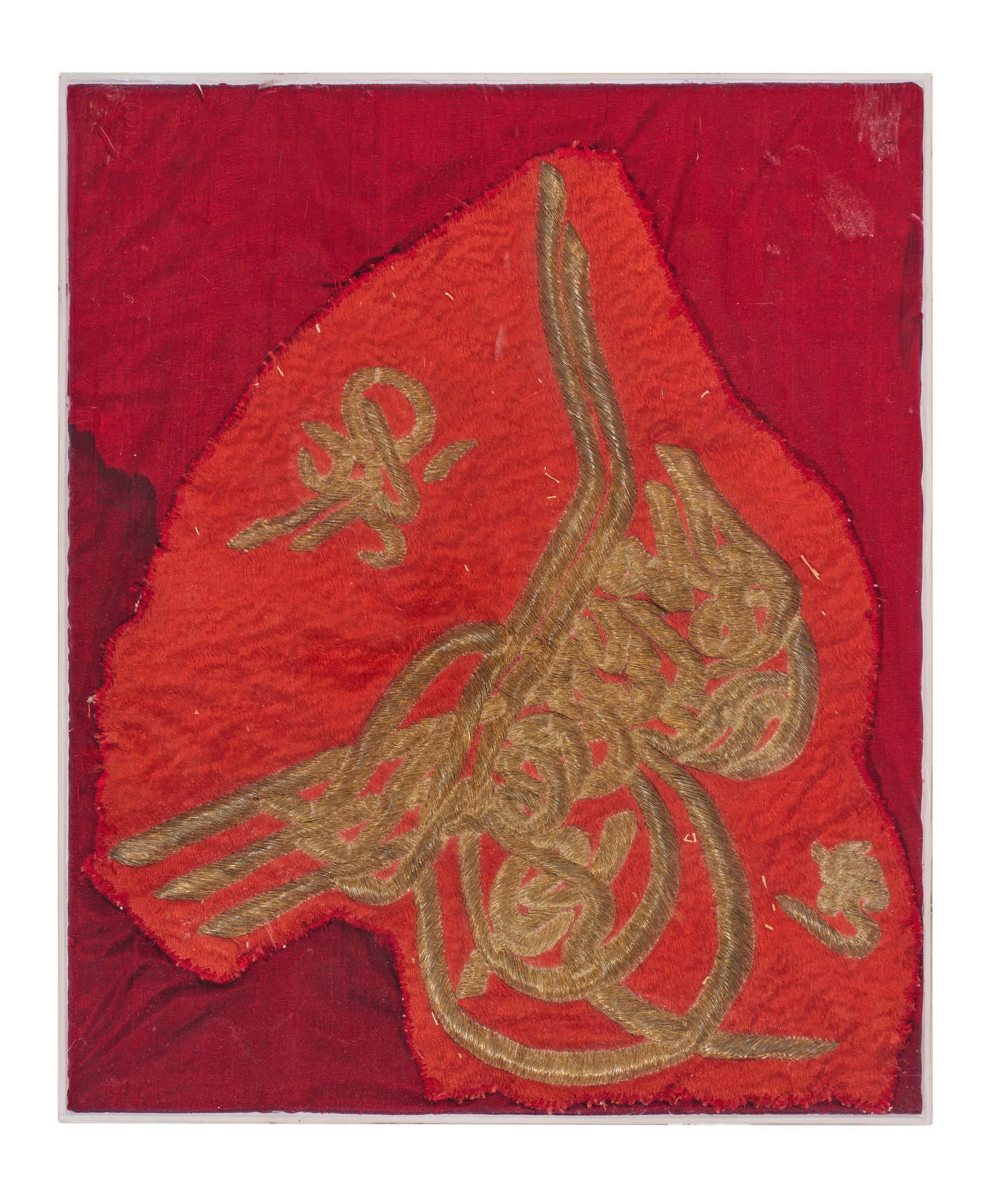 AN OTTOMAN METAL THREAD EMBROIDERY TEXTILE WITH TUGHRA, TURKEY, 19TH CENTURY: AN OTTOMAN METAL THREAD EMBROIDERY TEXTILE WITH TUGHRA, TURKEY, 19TH CENTURY This framed textile fragment from the Ottoman Empire features an imperial calligraphic monogram, or tughra, executed in ra