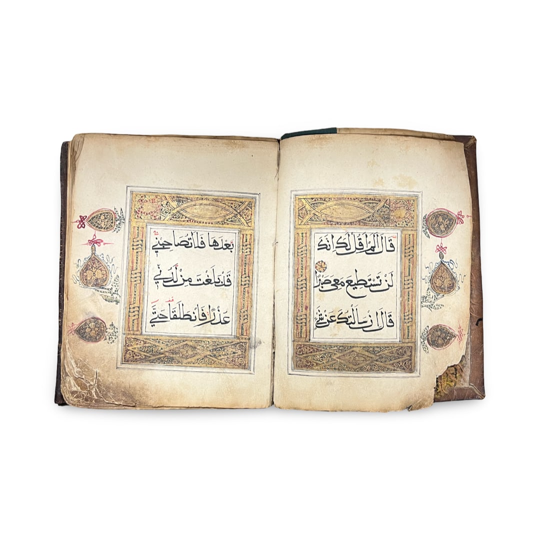 A CHINESE QURAN SECTION (JUZ), 18TH CENTURY: This 18th century Chinese Quran section (juz) is an Arabic manuscript executed on handmade cream paper. The volume is bound in a dark brown leather hardcover featuring heavy blind-tooling and embossin