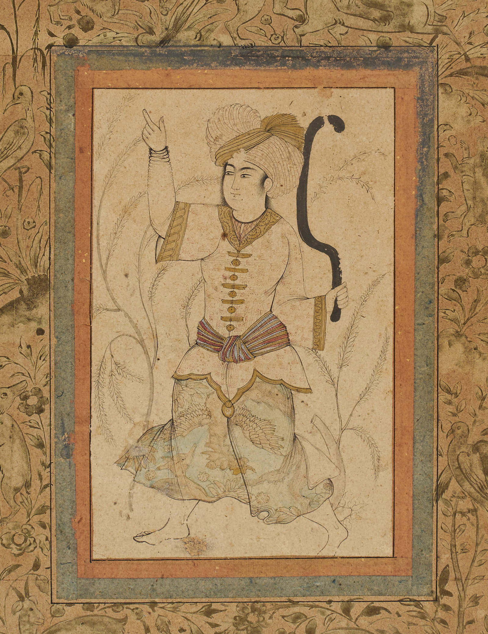 A SAFAVID MINIATURE PAINTING DEPICTING A COURTLY YOUTH REZA ABBASI STYLE, PERSIAN, 17TH CENTURY: Features a courtly youth standing in a landscape, dressed in a voluminous striped turban with a plume, a short-sleeved tunic with gold frogging, and a striped patka at the waist. The trousers are deco