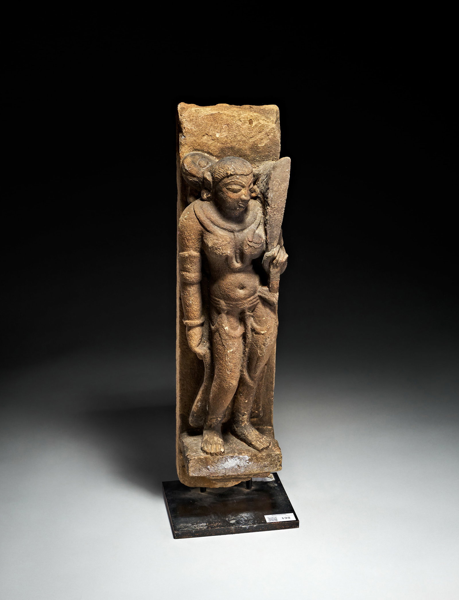 AN INDIAN STONE FIGURE OF A SURASUNDARI, CENTRAL INDIA, CIRCA 10TH CENTURY: AN INDIAN STONE FIGURE OF A SURASUNDARI, CENTRAL INDIA, CIRCA 10TH CENTURY An Indian stone figure of a surasundari, Central India, circa 10th century. This carved stone architectural relief fragment