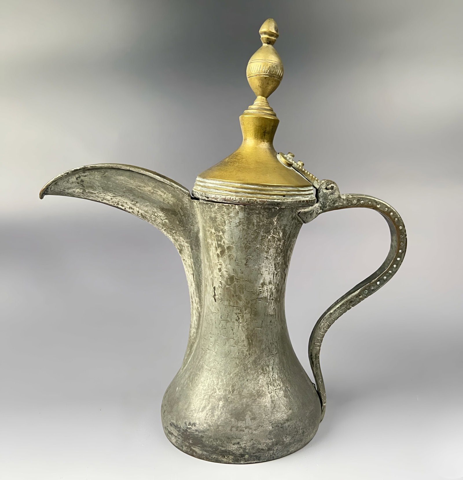 A MIDDLE EASTERN TINNED COPPER DALLAH COFFEE POT, SAUDI ARABIA, 19TH - 20TH CENTURY (1 of 6)