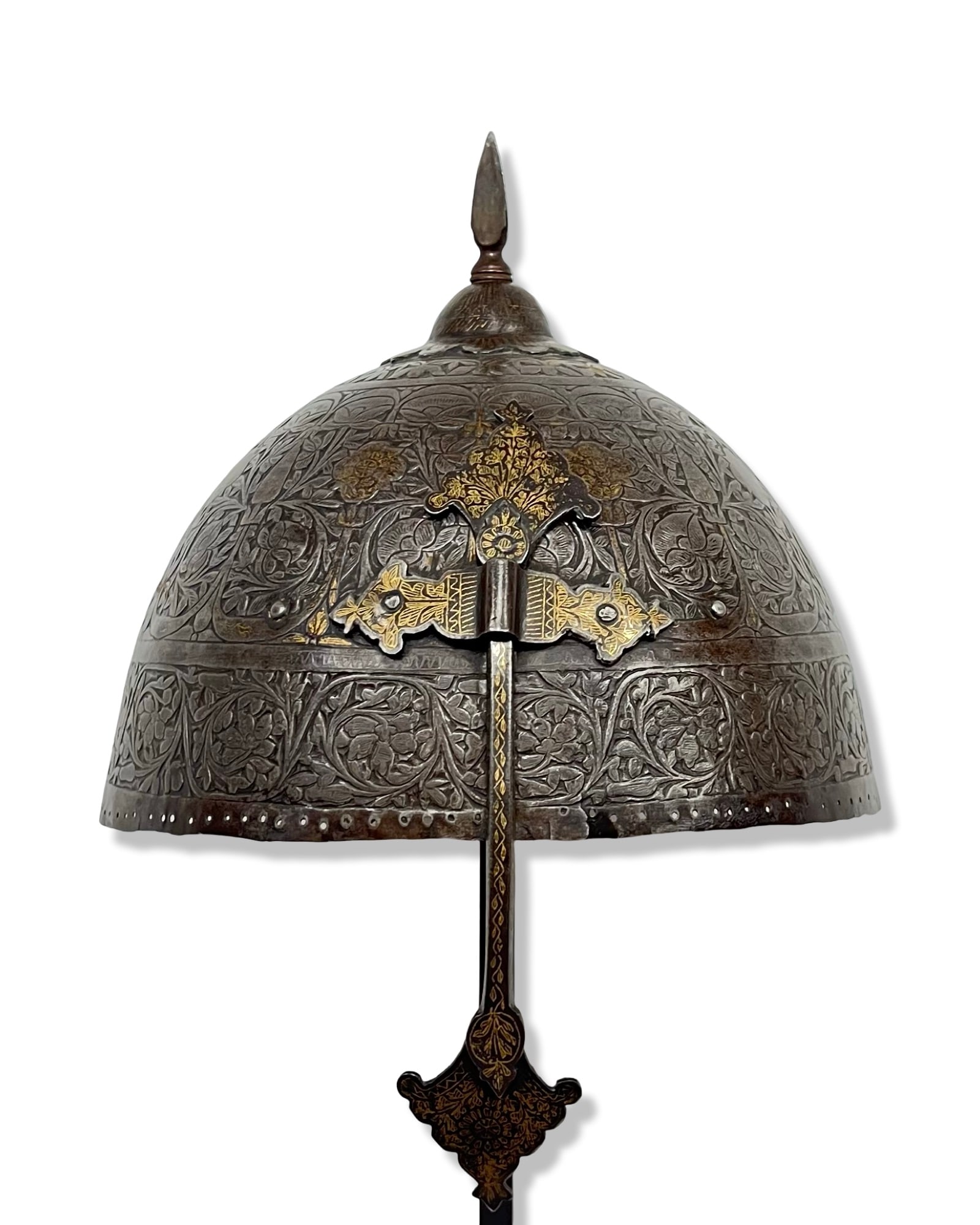 AN INDO-PERSIAN KULAH KHUD STEEL HELMET WITH FLORAL DESIGN, 19TH CENTURY: This 19th-century Indo-Persian kulah khud helmet consists of a hemispherical bowl forged from steel. The exterior surface is extensively decorated with hand-engraved and chased scrolling foliate and f