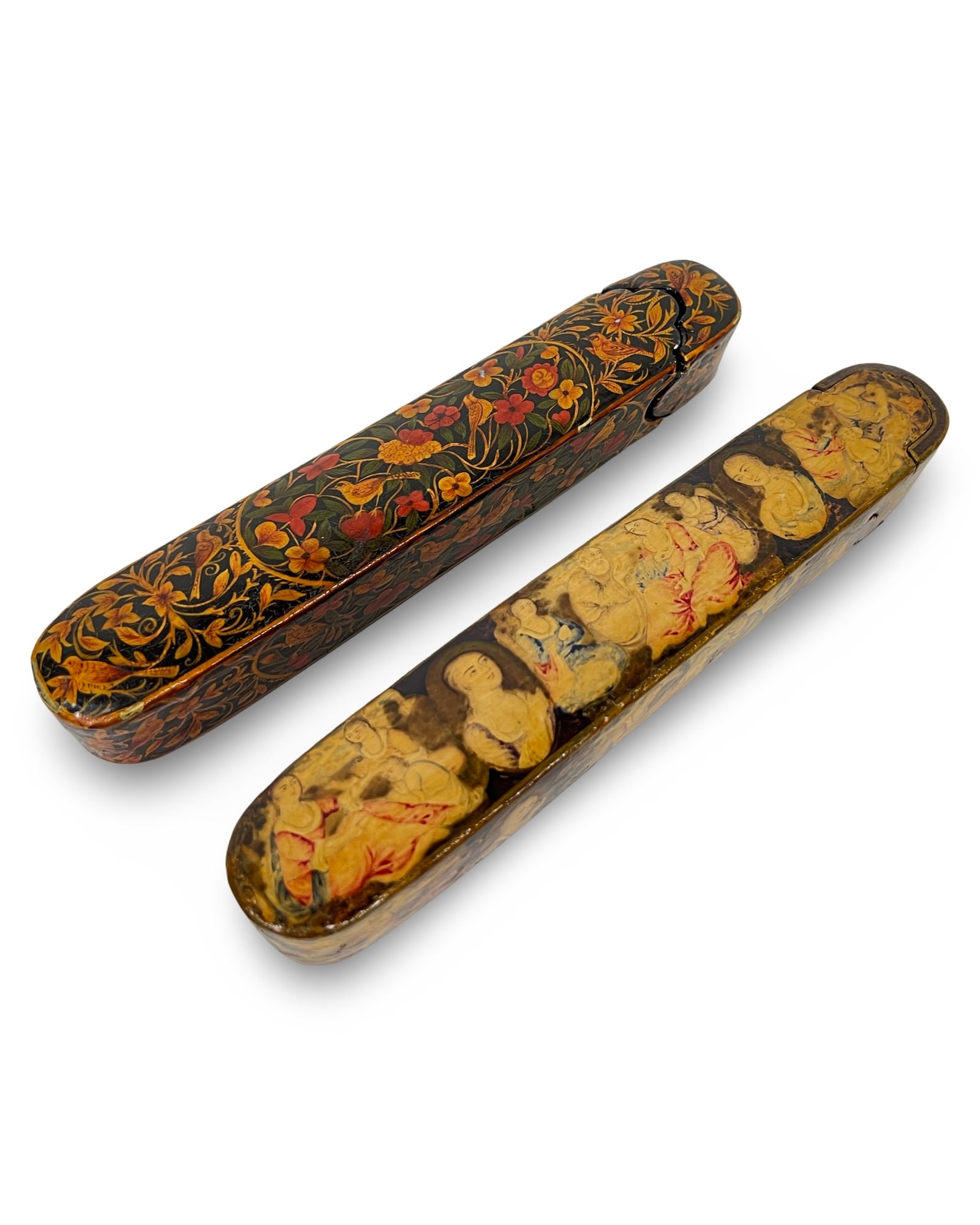TWO PERSIAN QAJAR LACQUERED PAPIER-MACHE PEN BOXES, 19TH CENTURY: Two Persian qalamdans from the Qajar period, constructed from hand-painted lacquer over papier-mache cores. One box is decorated in the traditional gul-o-bulbul style, featuring dense polychrome flora