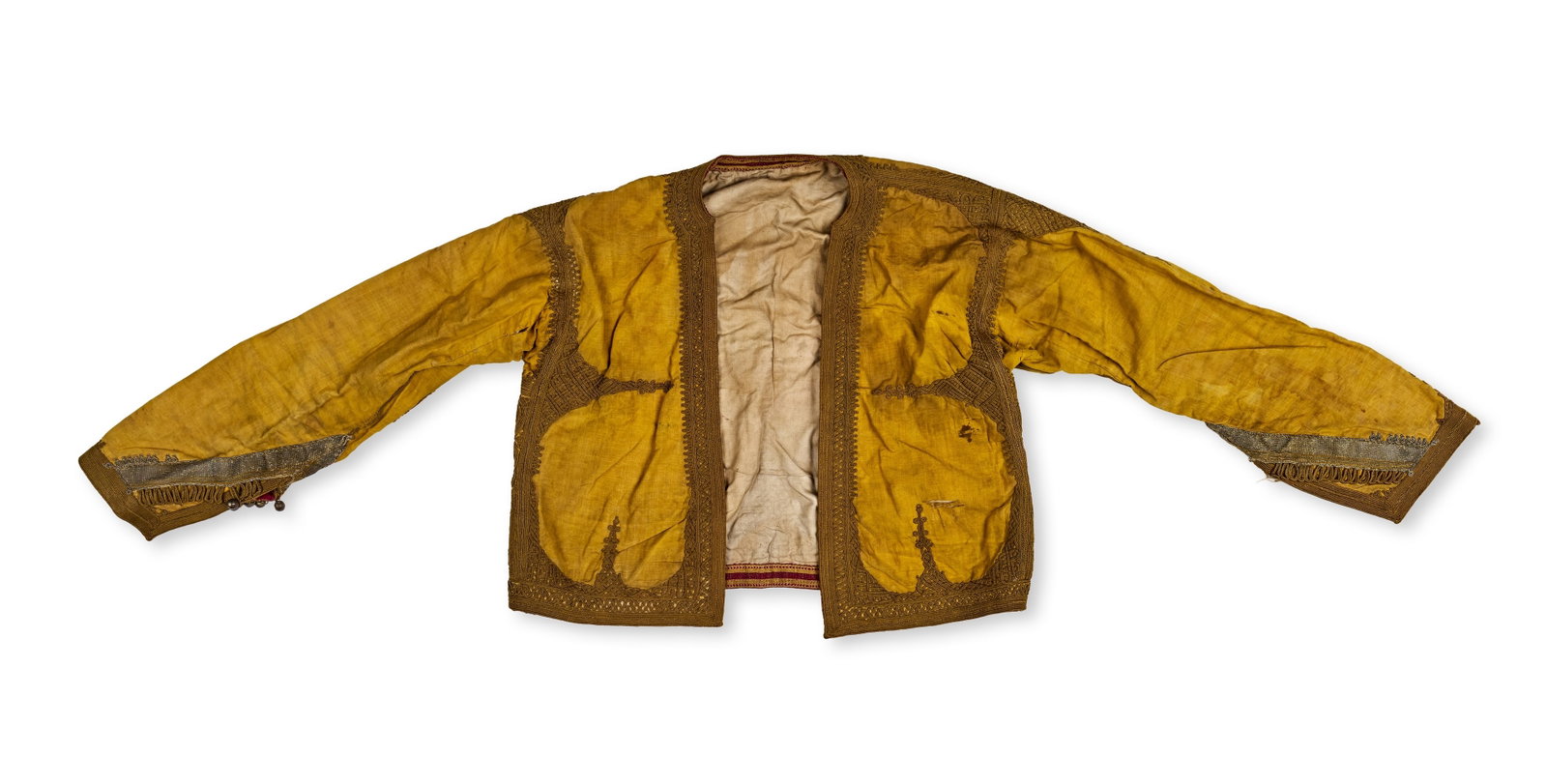 AN OTTOMAN OR BALKAN EMBROIDERED SHORT METALLIC EMBROIDERED JACKET, LATE 19TH CENTURY: An antique short-waisted jacket of Ottoman or Balkan origin, of the type often identified as a cepken or pisli. The garment is constructed from a gold-coloured finely woven fabric, likely silk or high