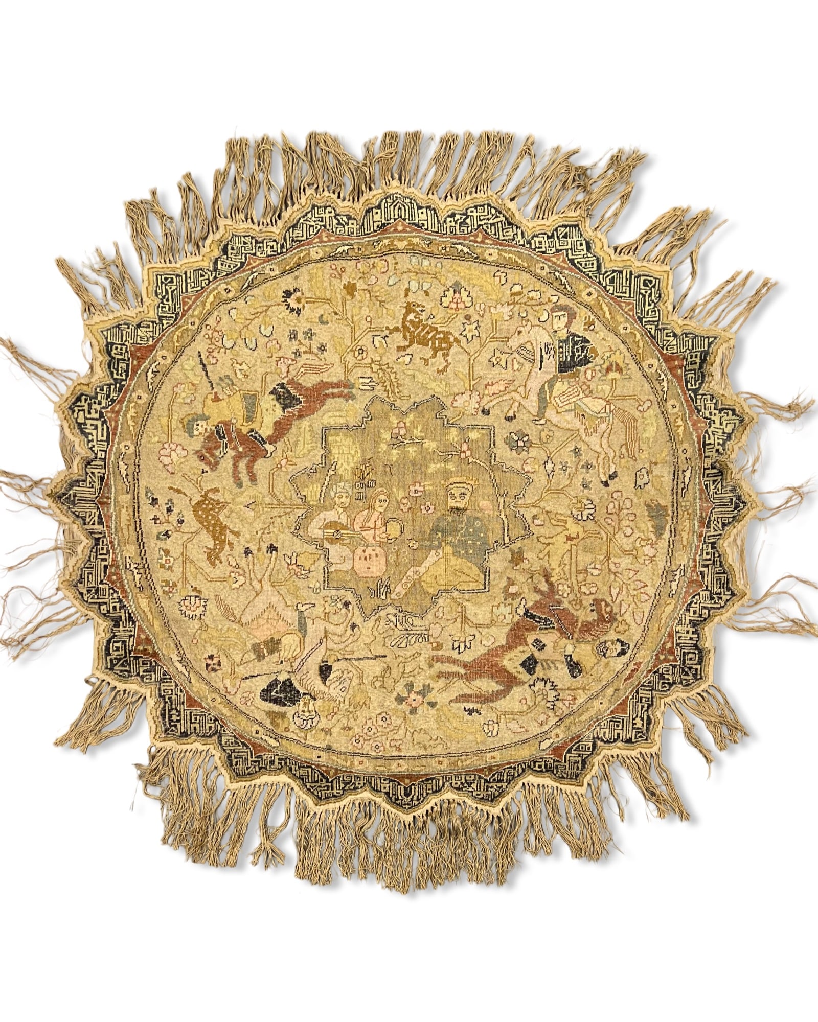 A CIRCULAR TURKISH KAYSERI WOOL AND METALLIC THREAD PICTORIAL RUG, 19TH - 20TH CENTURY: The central lobed medallion depicts a courtly garden scene with three seated figures, one of whom is playing a musical instrument. The surrounding field is decorated with a Shikargah hunting scene, fe