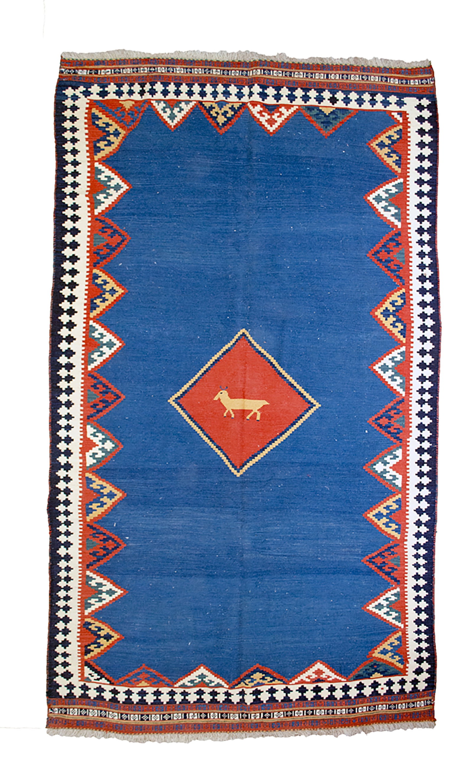A QASHQAI HAND-WOVEN WOOL KILIM RUG WITH ANIMAL MOTIF: This is a hand-woven Qashqai wool kilim rug featuring a flat-weave construction. The design is centred around a large, vibrant cobalt blue field containing a red diamond-shaped medallion. Within the m
