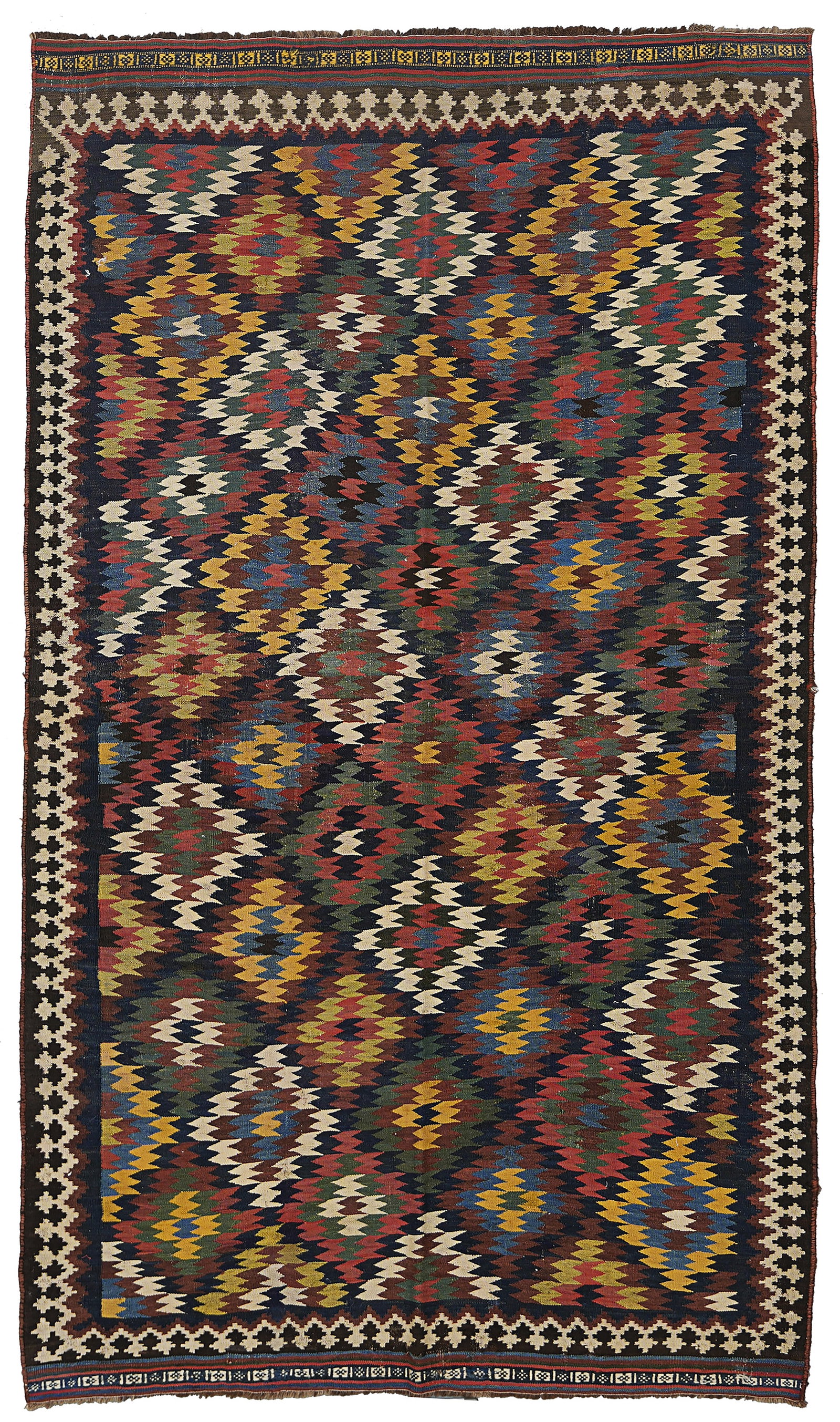 A PERSIAN QASHQAI KILIM RUG, CIRCA 1900: A large hand-woven Qashqai kilim rug originating from Southwest Persia, dating to approximately 1900. The rug features an all-over geometric design composed of interlocking stepped diamonds and dense 