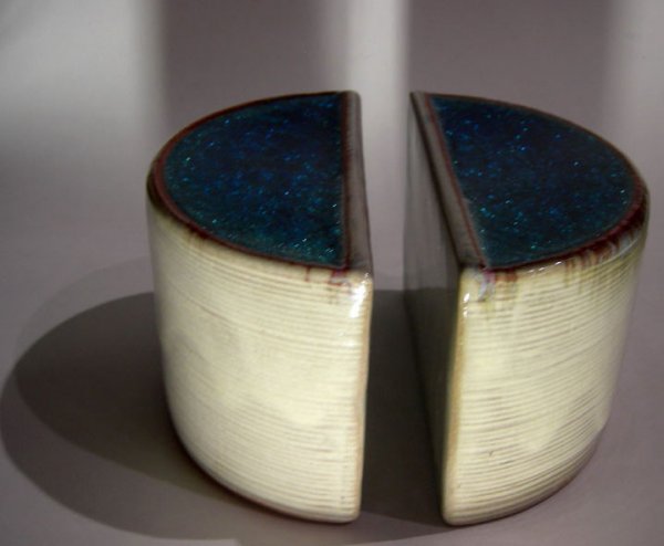 MID CENTURY MODERN EAMES DESIGN TECHNICS BOOKENDS: Sculptural incised demilune shaped ceramic bookends topped with thick blue translucent crackle glaze. Embossed DESIGN TECHNICS on the back of each piece. Each piece measures 4" t x 3" w x 6" d. Alfred