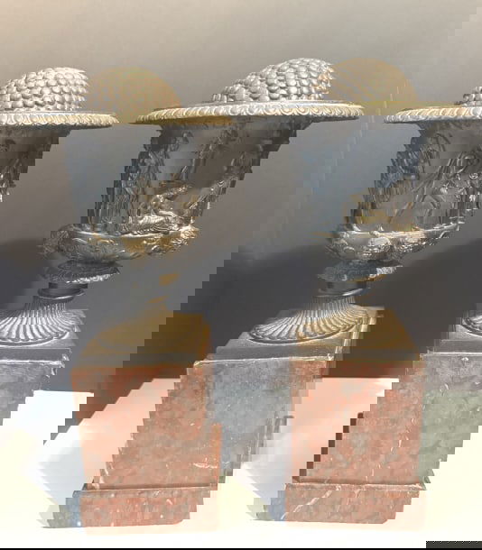 ANTIQUE REPLICAS OF THE BORGHESE VASE 19TH CENTURY: As we know the original is in the Louvre. this pair is 19th century, bronze on rouge marble bases, that illustrate Bacchus the god of wine along with his follwers. we have included 2 round bronze ball