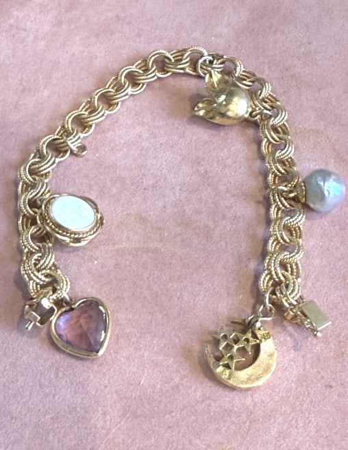 VINTAGE 14KT YELLOW GOLD CHARM BRACELET: With fancy heavy link chain, 8" in length, with 5 charms, 3@ 10 kt, and 2@ 14kt, total weight 15.5 dwt, from a Miami Beach judges estate