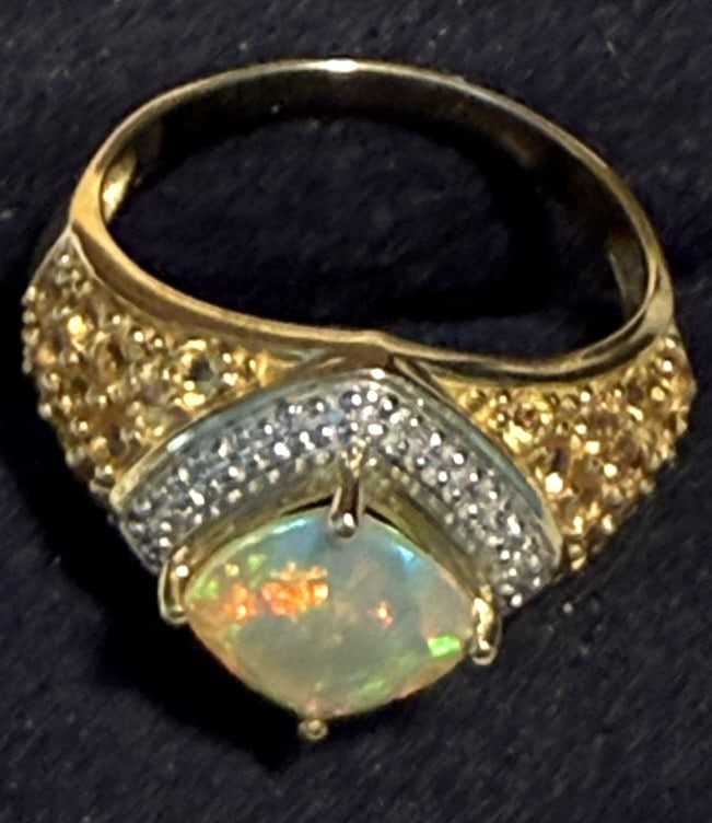 10KT Y.G CUSHION CUT OPAL AND DIAMOND LADIES RING: Size 7, with large cushion cut round opal, accented halo diamonds, total weight 3dwt