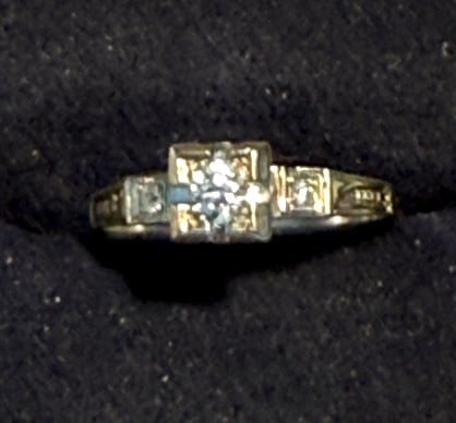 ART DECO CRAFTED 14KT W.G. DIAMOND ENGAGEMENT RING: size 6, with .20 center stone round brilliant cut, along with 2 smaller stones to either side, total weight of the ring 1.1 dwt