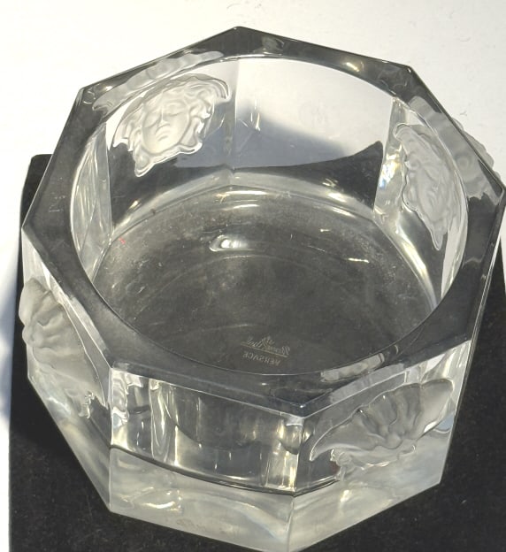 VERSACE LUMINERE MEDUSA CRYSTAL WINE BOTTLE HOLDER: DESCRIPTION: Versace Rosenthal crystal wine holder crafted in an octagonal design and featuring four Medusa heads in high relief on its exterior. comes with box Marked "Rosenthal Versace" on underside