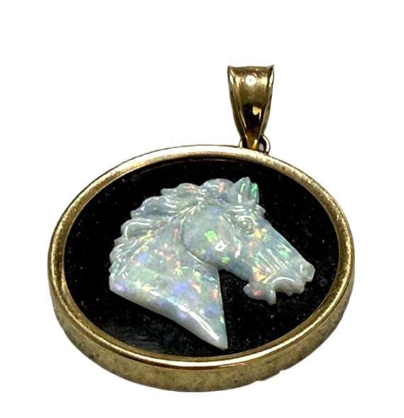 VINTAGE 14KT Y.G OPAL CARVED HORSE ON ONYX PENDANT: About 1" in diameter, with opal carving of a thoroughbred horse in onyx mounted in 14 kt yellow gold, weighs 3 6 dwt