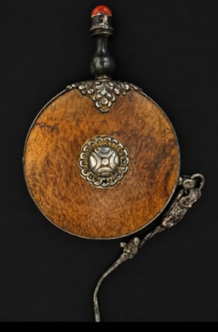 RARE 19TH CENTURY TIBETIAN SNUFF BOTTLE: Crafted from burl wood with silver alloy fittings coral inlay, and long cord