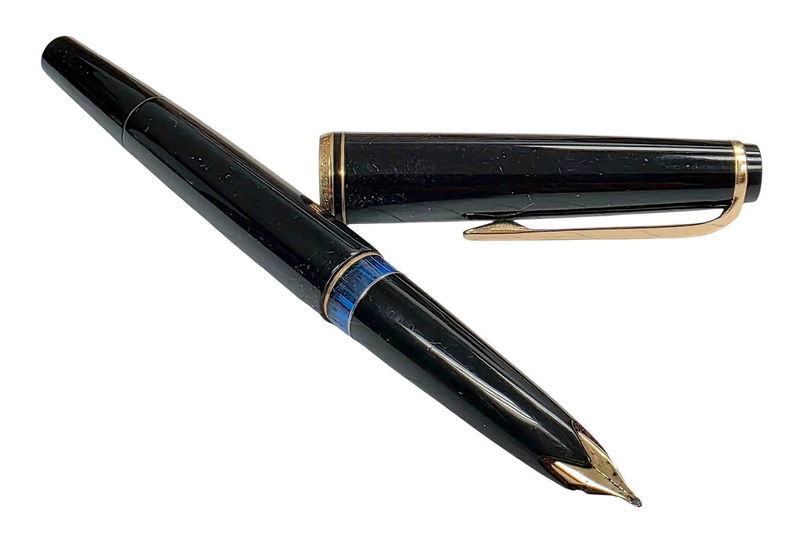 Vintage Montblanc No. 22 Fountain Pen: A vintage Montblanc No. 22 piston-filler fountain pen featuring a black finish with gold-tone accents. The pen is designed with a semi-hooded wing nib, an integrated blue-tinted transparent ink inspec