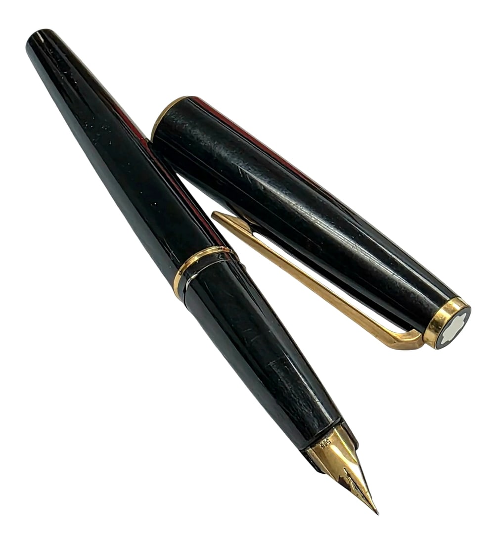 Vintage Montblanc Fountain Pen with 585 Nib: A vintage Montblanc fountain pen featuring a glossy black finish, gold-tone clip, center accent ring, and gold-tone cap top ring inlaid with the Montblanc white star finial emblem. The pen is equipped