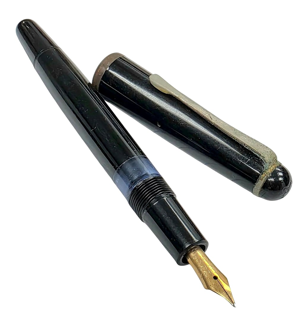 Vintage Black Piston-Filler Fountain Pen with Gold-Tone Nib: Vintage fountain pen featuring a glossy black finish, screw-on cap with a rounded dome finial, collar-mounted pocket clip, single cap band, transparent blue-tinted ink view window section, and a taper