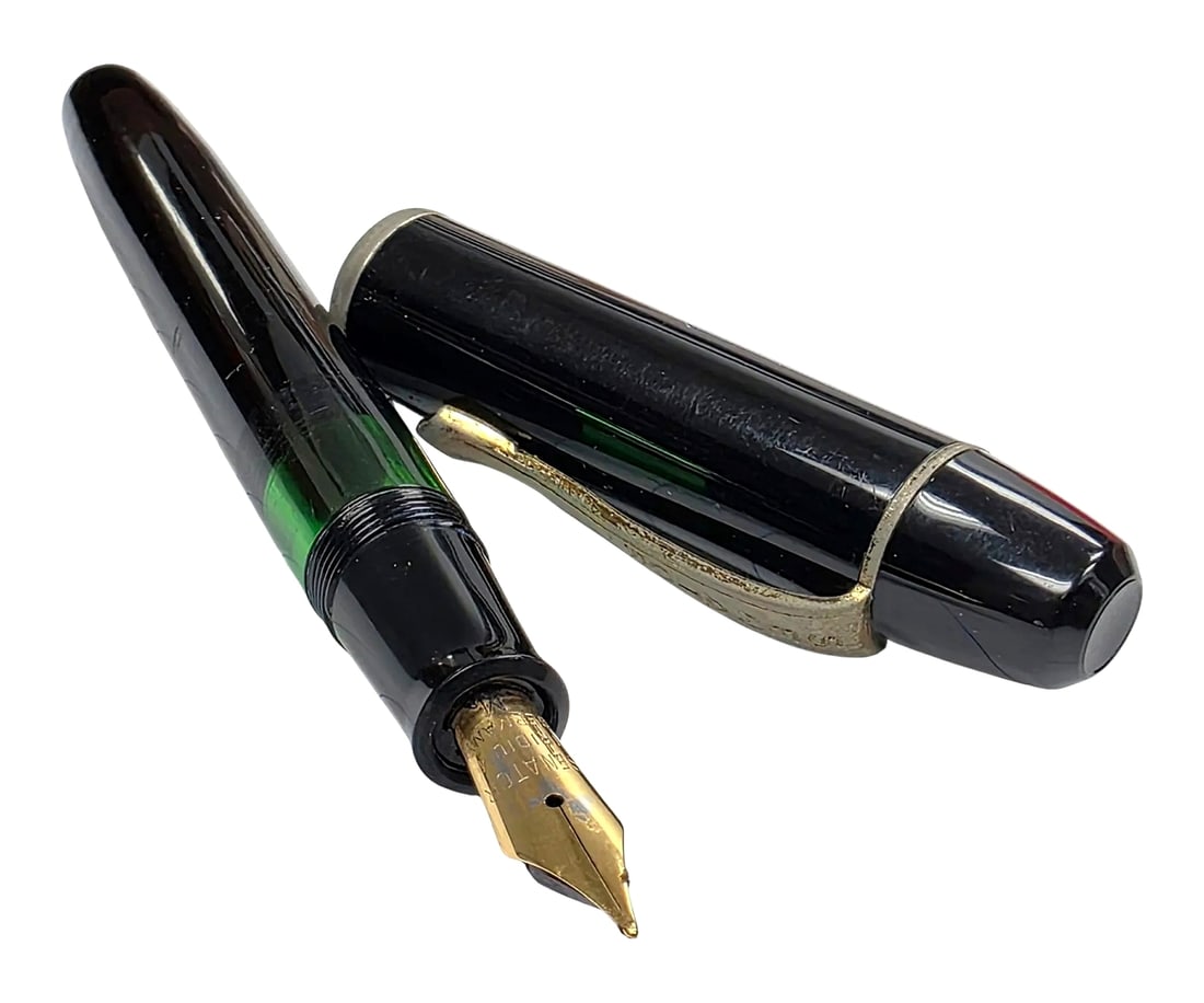 Vintage Senator Regent Piston-Filler Fountain Pen: A vintage Senator Regent piston-filler fountain pen, manufactured in Germany by Merz & Krell under the Senator brand. The pen features a glossy black finish accented by a translucent green ink viewing
