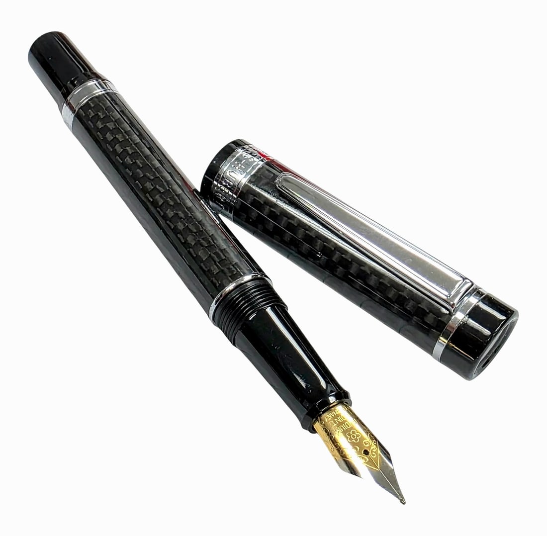Charles-Hubert Paris Black Carbon Fiber Pattern Fountain Pen, Model D2027-FB: A Charles-Hubert, Paris fountain pen (model D2027-FB) featuring a woven black carbon fiber pattern on the barrel and cap. The pen is fitted with polished silver-tone trim, including a spring clip and 