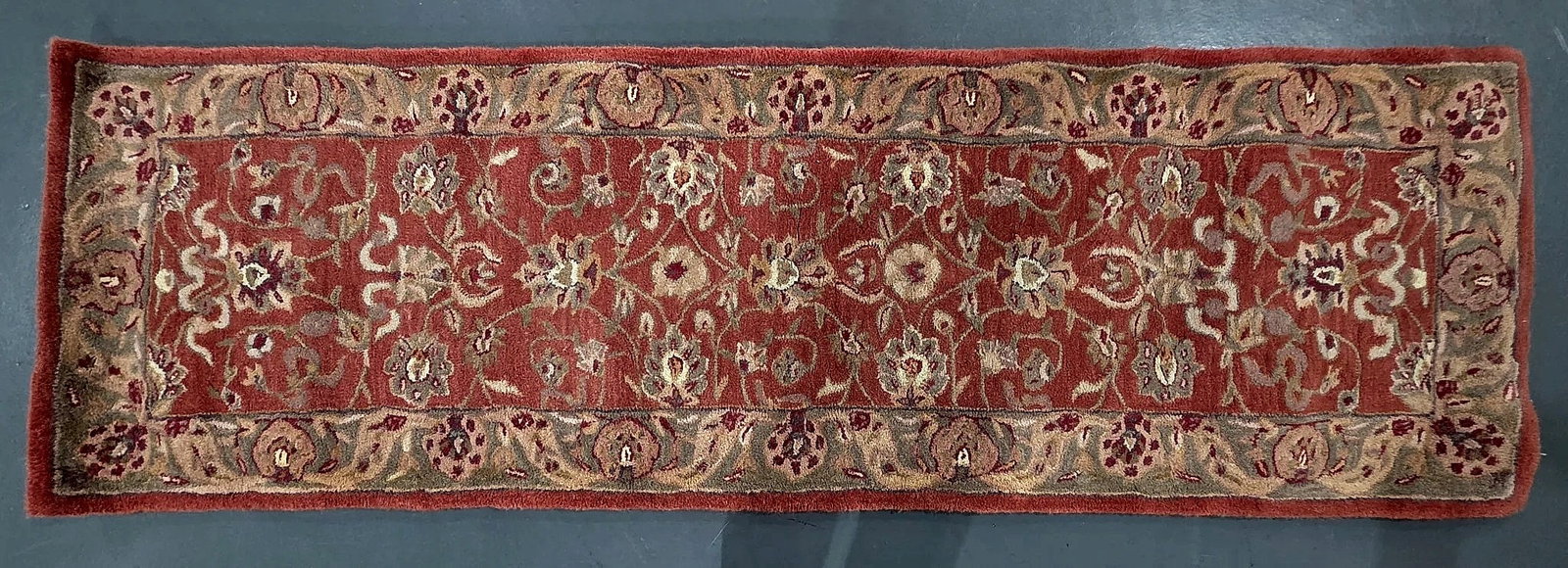 Kenneth Mink Traditional Floral Pattern Runner Rug: Traditional style runner rug by Kenneth Mink. The design features a rust-red field decorated with scrolling floral vines and palmettes, surrounded by an olive and taupe floral border. The reverse is