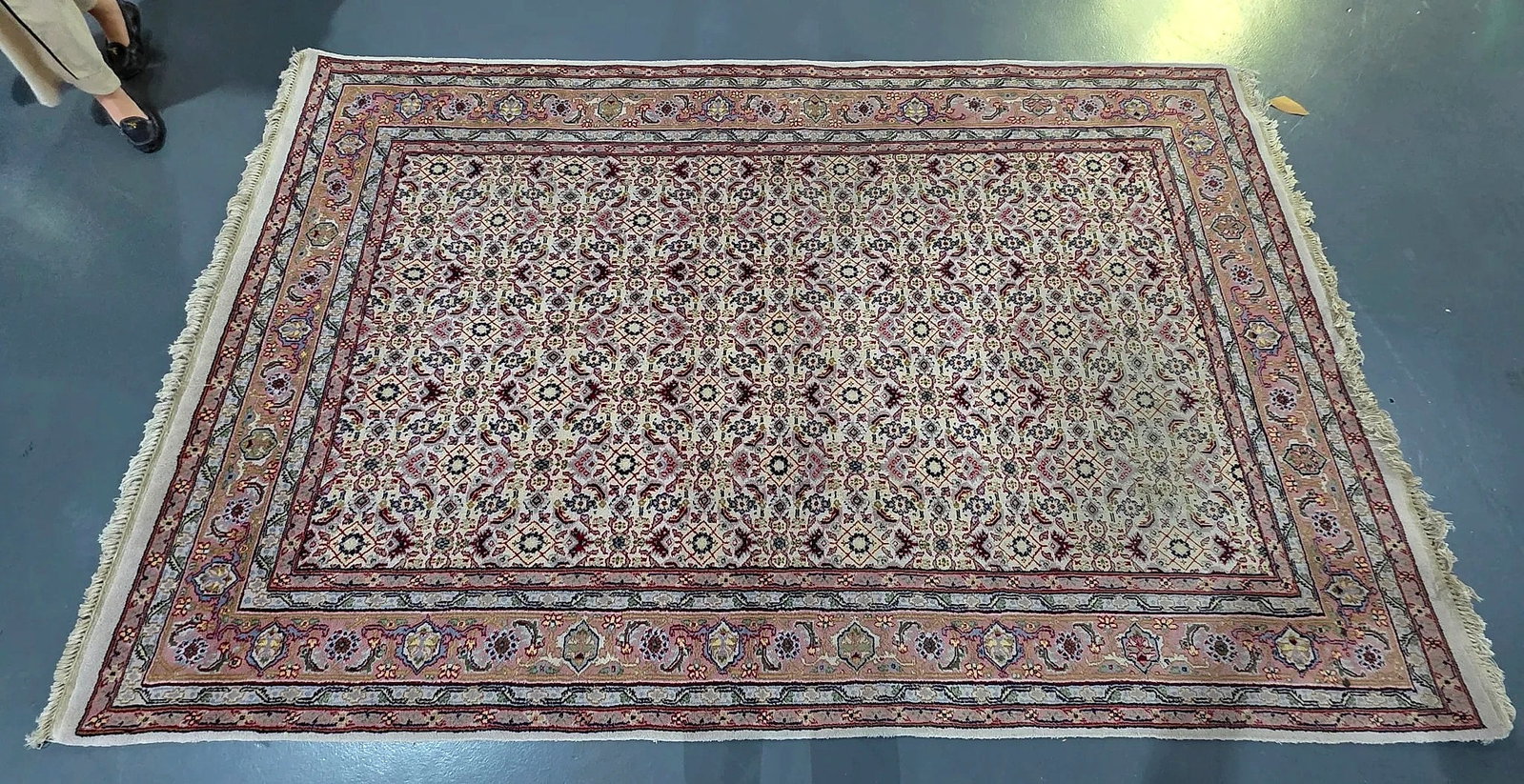 Khurram Carpets Limited Bhadohi Patterned Area Rug: A rectangular area rug produced by Khurram Carpets Limited of Bhadohi, Uttar Pradesh, India. The rug features an all-over repeating floral lattice and palmette field in tones of cream, rose, tan, and