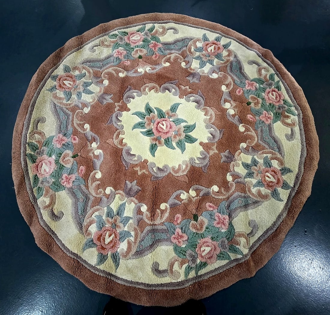 Vintage Chinese Aubusson Style Sculpted Round Floral Medallion Area Rug: A circular area rug executed in a Chinese Aubusson style. The design features a central cream scalloped medallion displaying a pink floral bouquet, set against a mauve-brown field with scrolling
