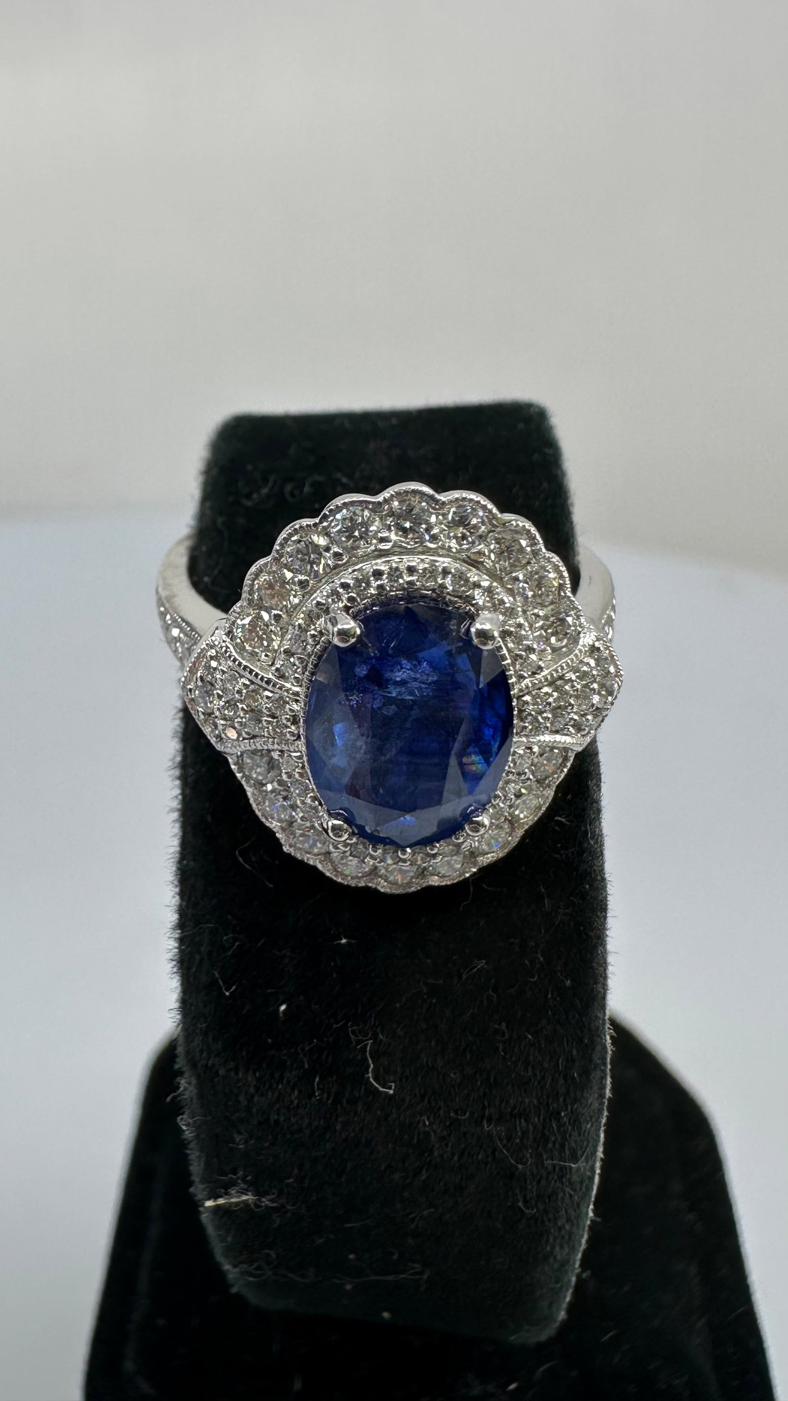 GIA Certified 3.01 Ct Natural Blue Sapphire & Diamond Platinum Ring: A stunning platinum natural blue sapphire and diamond halo ring featuring a GIA-certified 3.01 carat natural blue sapphire. The vibrant oval sapphire is surrounded by a halo of brilliant diamonds with
