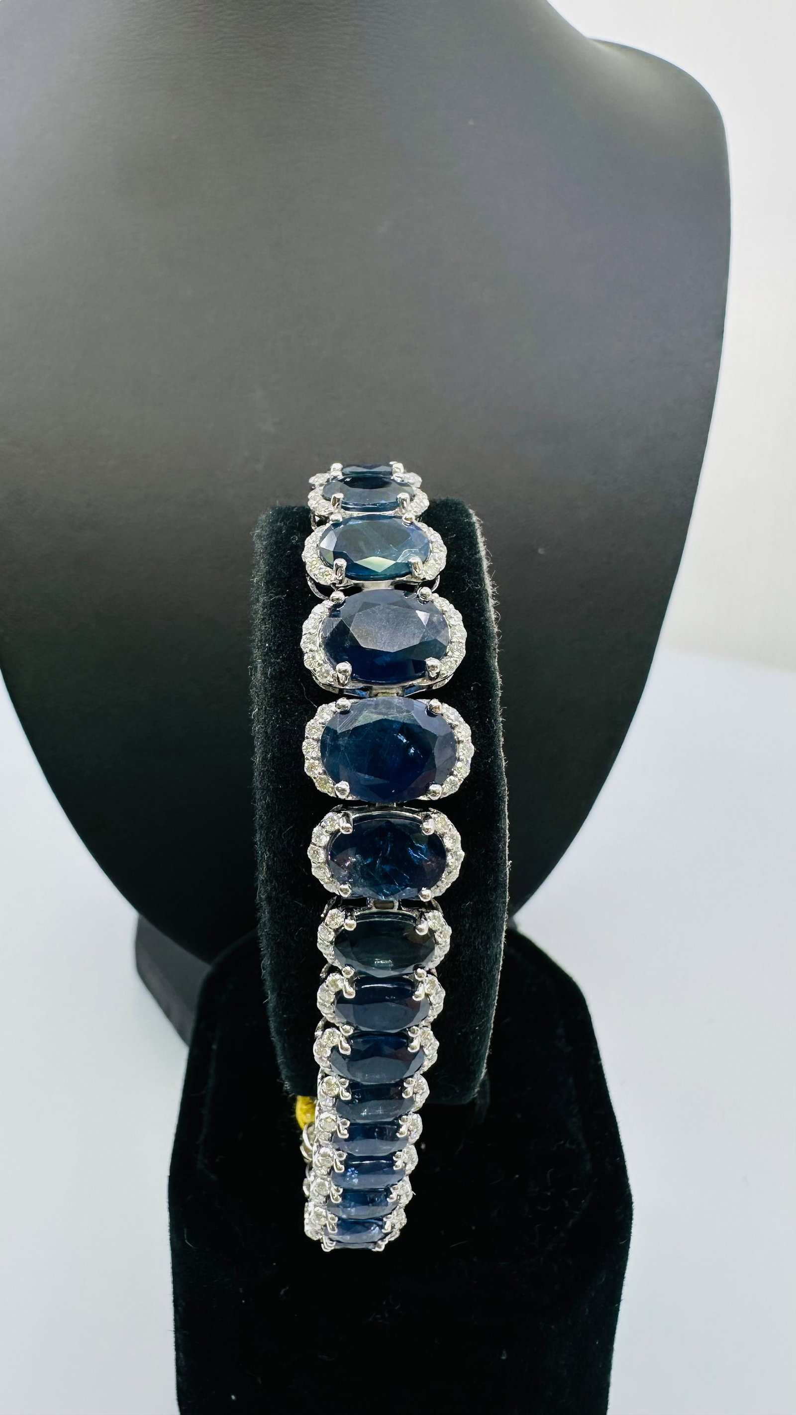 Platinum Natural Blue Sapphire & Diamond Bracelet ? 28.61 CTW Sapphire: An extraordinary platinum bracelet showcasing 36 natural blue sapphires totaling approximately 28.61 carats. Each oval brilliant-cut sapphire displays a rich, intense blue color and is beautifully acc