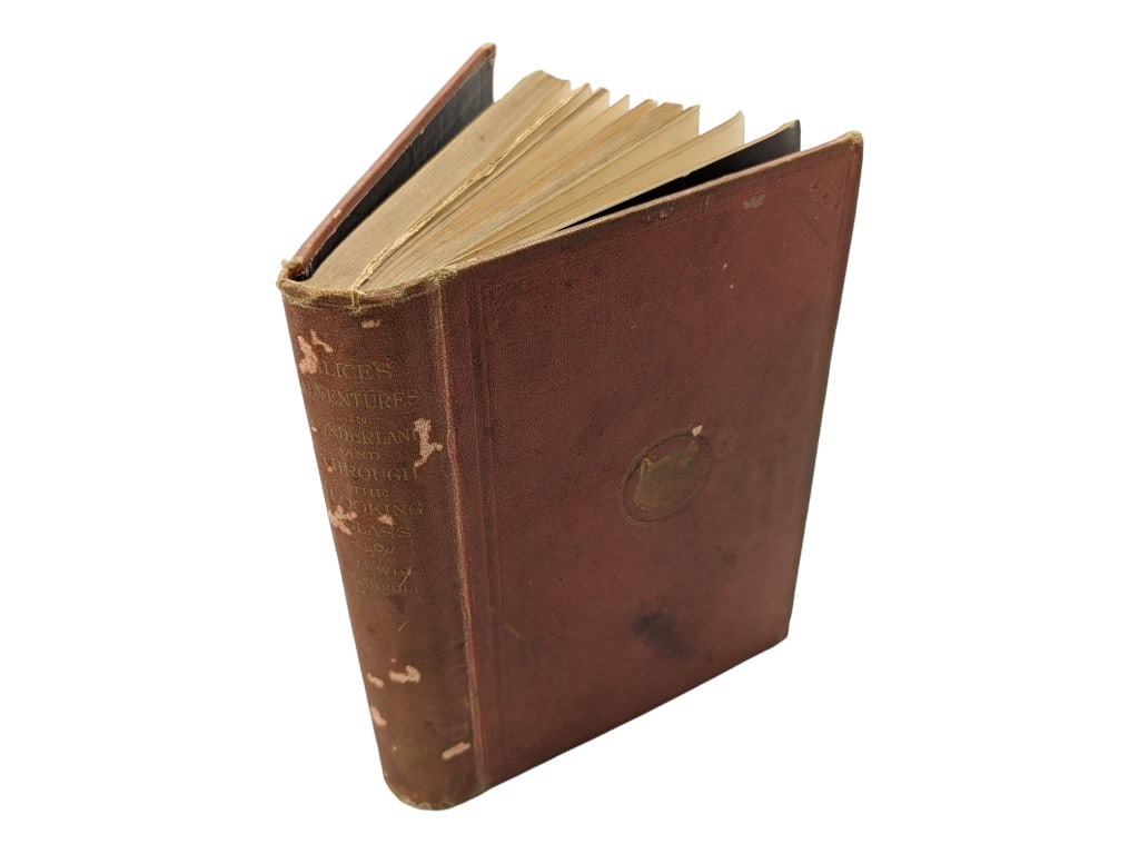Alice's Adventures in Wonderland and Through the Looking Glass by Lewis Carroll 1885: Book is in fair condition with blemishes on the cover, foxing and possible small handwritten inscription. Pages are legible and can be turned. Spine is attached.