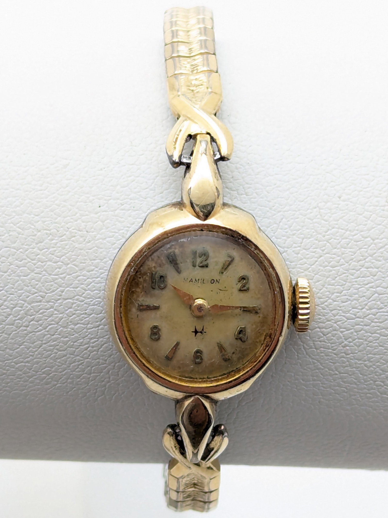 Antique Hamilton Women's 10k Gold Fill Mechanical Winding Watch: This is a vintage Hamilton. The crystal shoudl be cleaned or replaced. The watch still runs. Make/Model: Hamilton Movement: Manual Wind Case: 10K Gold Filled Bezel Band: Gold tone, Length is 5.5in and