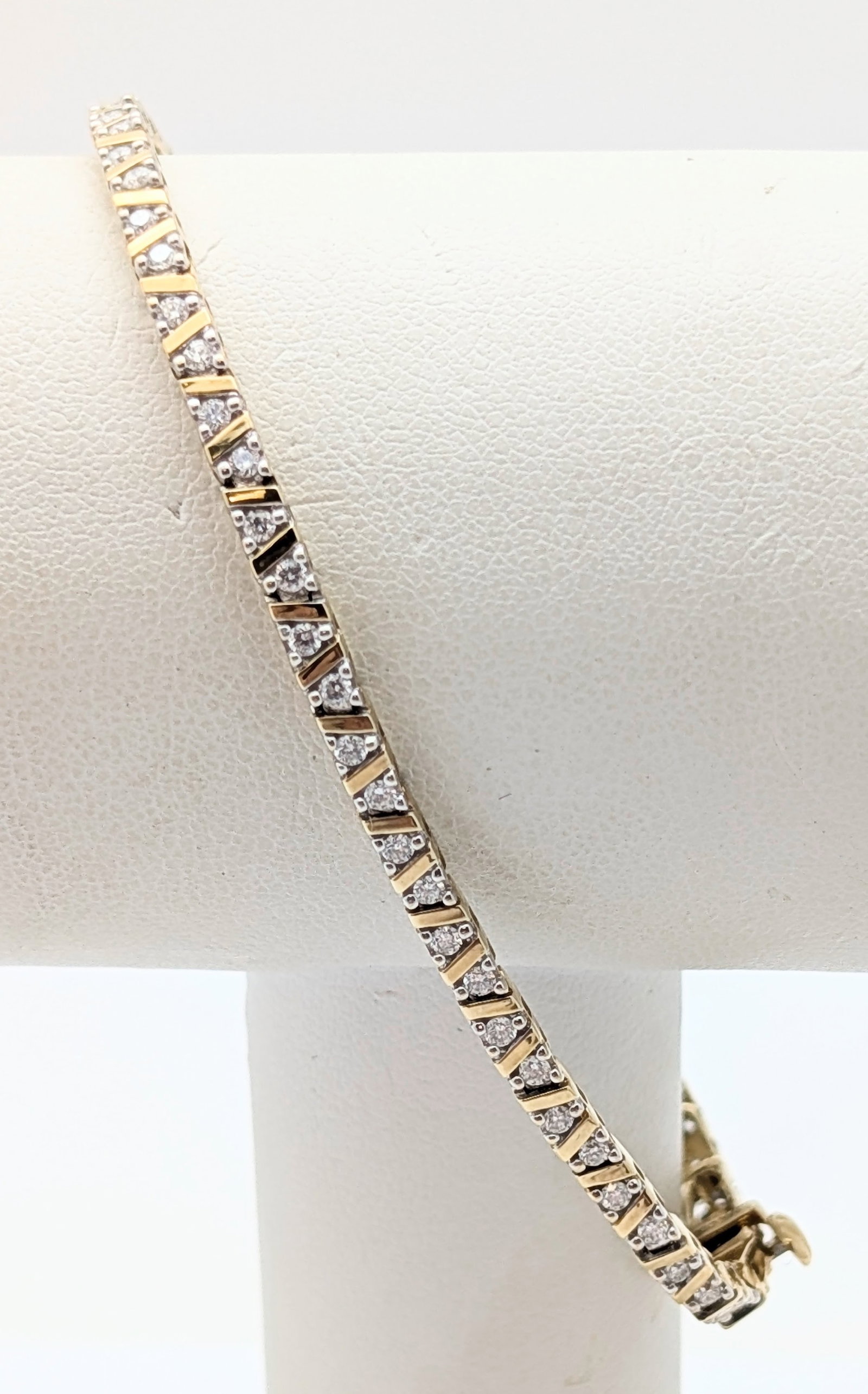 Helzberg Diamonds - 10K Gold Diamond Ladies Tennis Bracelet: Weight: 6.63 grams 66 diamond chips, possibly 1/64 ct Length: 7in 