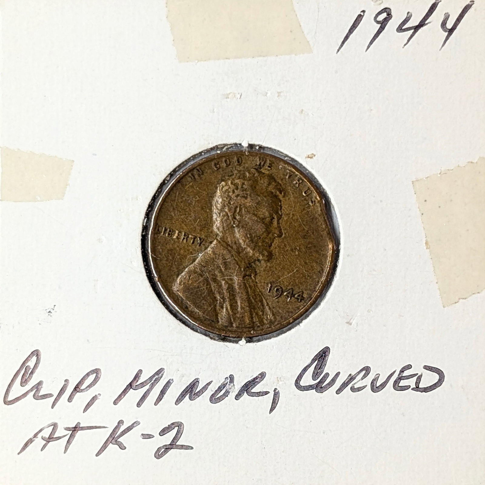 1944 Clipped Lincoln Cent: Notes on coin say "Clip, minor curved ATK-2"